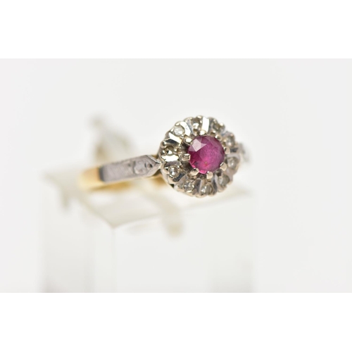 11 - A MID 20TH CENTURY 18CT GOLD RUBY AND DIAMOND CLUSTER RING, set with a circular cut ruby, measuring ... 