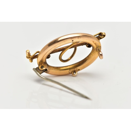 19 - A LATE VICTORIAN HUNTING BROOCH, of an oval openwork form, displaying a riding crop and rope, approx... 