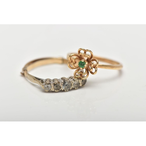 23 - TWO GEM SET RINGS, the first a designed as a small openwork flower centering on a small claw set eme... 