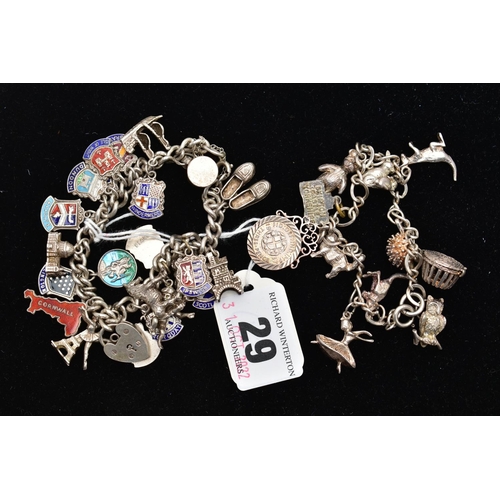 29 - TWO SILVER CHARM BRACELETS, the first fitted with eleven charms in forms such as a kangaroo, cat, te... 