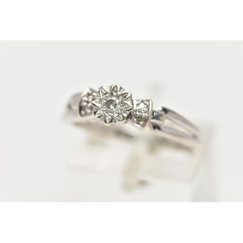 35 - A 9CT WHITE GOLD DIAMOND RING, centering on an illusion set round brilliant cut diamond, flanked wit... 