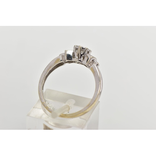 35 - A 9CT WHITE GOLD DIAMOND RING, centering on an illusion set round brilliant cut diamond, flanked wit... 