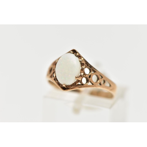 36 - A 9CT GOLD OPAL RING, designed with an oval opal cabochon in a six claw setting, openwork detailed s... 