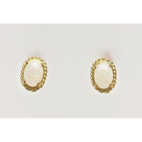 40 - TWO PAIRS OF OPAL EARRINGS, the first of an oval design, set with an oval opal cabochon, within a ro... 