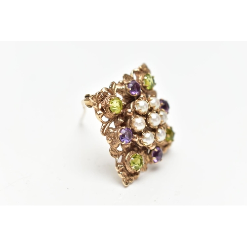 72 - A 9CT GOLD PERIDOT, AMETHYST AND SPLIT PEARL BROOCH, of openwork floral design, the center set with ... 