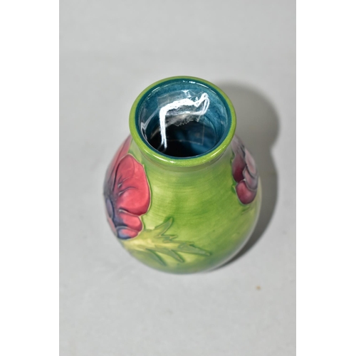 413 - A SMALL MOORCROFT POTTERY BALUSTER VASE, tube lined in Anemone pattern on a graduated green ground, ... 