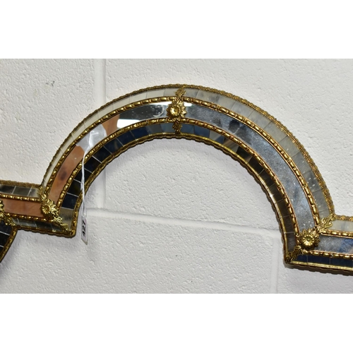 427 - A MIRRORED PICTURE FRAME, with gilt edges and foliate detail, height 150cm x width 85cm (1)