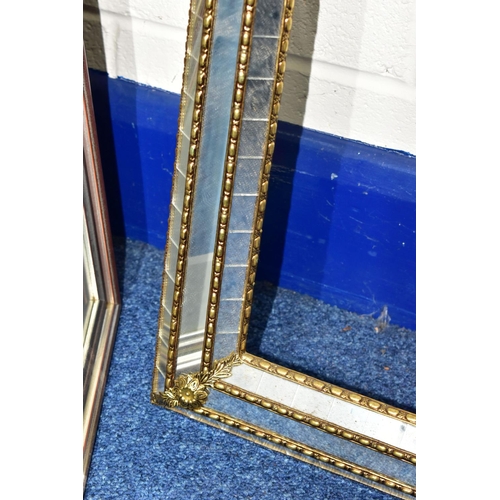 427 - A MIRRORED PICTURE FRAME, with gilt edges and foliate detail, height 150cm x width 85cm (1)