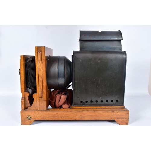36 - A 'KING ENLARGER' MAGIC LANTERN with an oak frame and tinplate body along with two covers