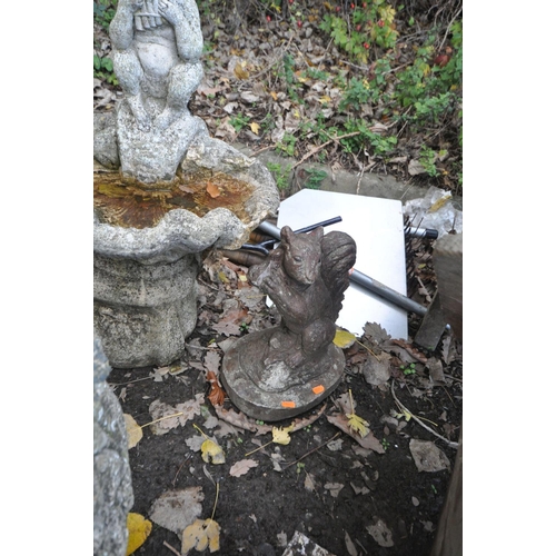 1016 - A COMPOSITE BIRD BATH in the form of a mythical figure playing pan pipes sat on an oyster shell bowl... 