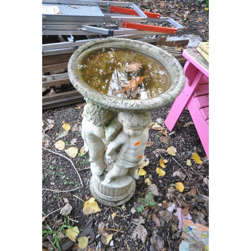 1018 - A COMPOSITE BIRD BATH in the form of three winged cherubs standing on a column holding the bowl alof... 