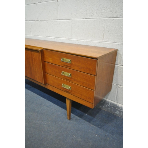 1202 - A MID CENTURY TEAK BEAUTILITY SIDEBOARD, with three drawers, two cupboard doors, flanking a pull out... 