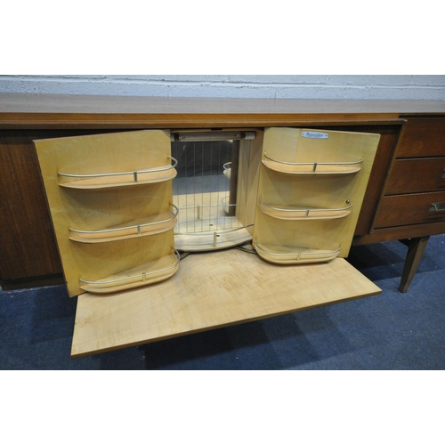 1202 - A MID CENTURY TEAK BEAUTILITY SIDEBOARD, with three drawers, two cupboard doors, flanking a pull out... 