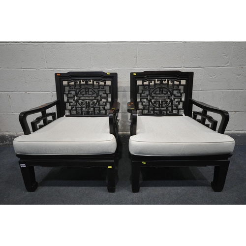 1210 - A PAIR OF ORIENTAL HARDWOOD ARMCHAIRS, with a cushion, width 67cm x depth 69cm x 82cm (2)