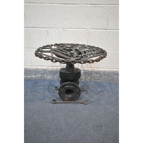 1216 - A BESPOKE OCCASIONAL TABLE, made up of mechanic tools and engine parts, with a glass top, diameter 6... 