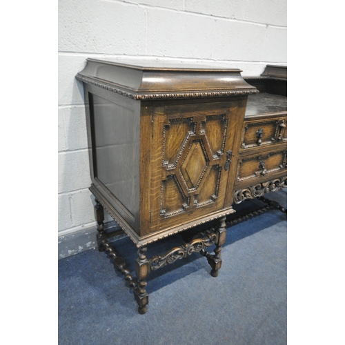 1220 - AN EARLY 20TH CENTURY OAK PEDESTAL SIDEBOARD, with geometric doors and drawers, on barley twist legs... 