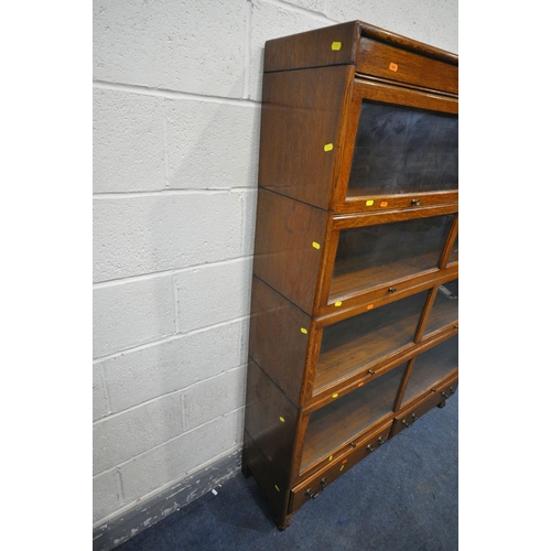 1240 - AN EARLY 20TH CENTURY OAK FOUR SECTION BOOKCASE, with twin glazed hide and fall doors, over a base w... 