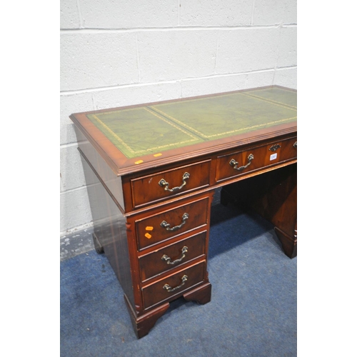 1241 - A YEWWOOD PEDESTAL DESK, with a green leather writing surface, and nine drawers, with one key, width... 