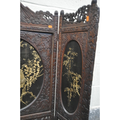 1249 - A 19TH CENTURY CARVED HARDWOOD ORIENTAL THREE FOLD FIRSCREEN, with three oval fabric chinoiserie pan... 