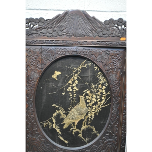 1249 - A 19TH CENTURY CARVED HARDWOOD ORIENTAL THREE FOLD FIRSCREEN, with three oval fabric chinoiserie pan... 