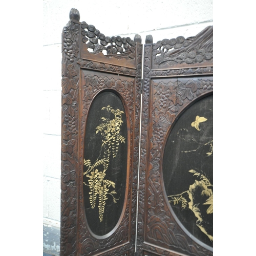 1249 - A 19TH CENTURY CARVED HARDWOOD ORIENTAL THREE FOLD FIRSCREEN, with three oval fabric chinoiserie pan... 