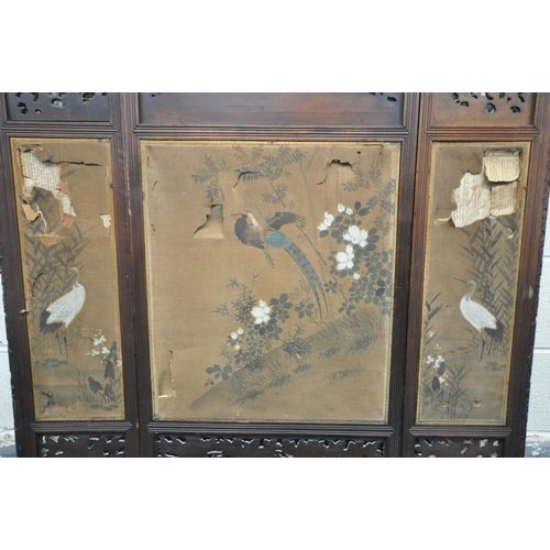 1249 - A 19TH CENTURY CARVED HARDWOOD ORIENTAL THREE FOLD FIRSCREEN, with three oval fabric chinoiserie pan... 