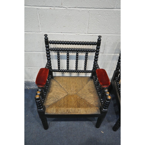 1262 - A PAIR OF 20TH CENTURY EBONISED BOBBIN TURNED ARMCHAIRS, with red velvet armrests, and rush seats, w... 