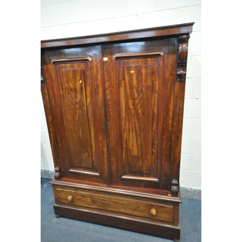 1291 - A VICTORIAN FLAME MAHOGANY TWO DOOR WARDROBE, enclosing a fitted interior, on a single long drawer, ... 