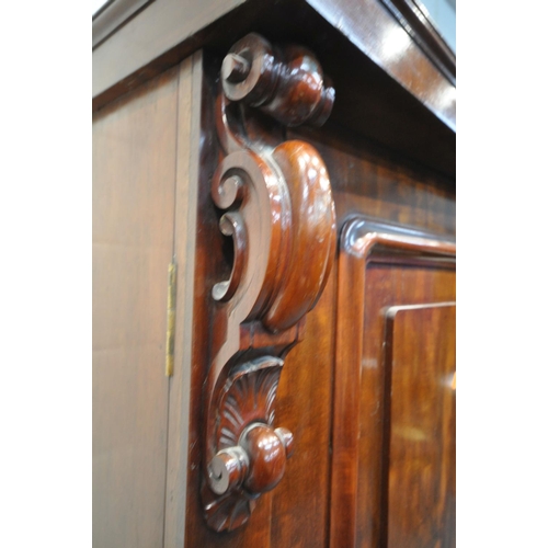 1291 - A VICTORIAN FLAME MAHOGANY TWO DOOR WARDROBE, enclosing a fitted interior, on a single long drawer, ... 