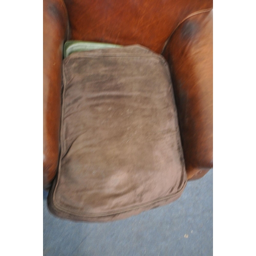 1304 - A TANNED LEATHER ARMCHAIR, with a replacement seat pad, width 94cm (condition - signs of usage)