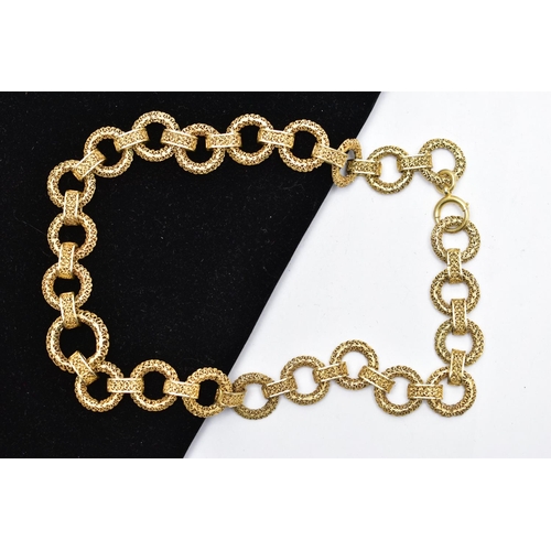 17 - A YELLOW METAL CHAIN NECKLACE, a wide chain comprised of hollow circular filagree links fitted toget... 