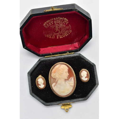 18 - A CAMEO BROOCH AND EARRING SET, a shell cameo depicting the profile of a lady facing right with a fl... 