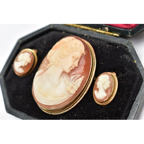 18 - A CAMEO BROOCH AND EARRING SET, a shell cameo depicting the profile of a lady facing right with a fl... 