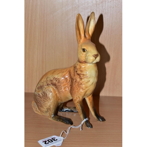 302 - A BESWICK FIGURE OF A SEATED HARE, model no 1025, tan gloss finish, issued 1945-1963, height 18cm, i... 