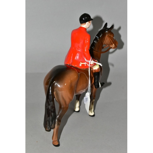 322 - A BESWICK HUNTSMAN FIGURE, model no 1501, style two : standing, the huntsman wearing a red jacket sa... 