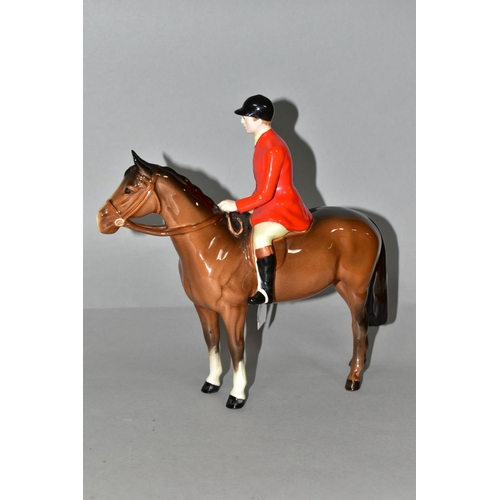 322 - A BESWICK HUNTSMAN FIGURE, model no 1501, style two : standing, the huntsman wearing a red jacket sa... 