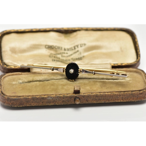 35 - A YELLLOW METAL DIAMOND SET BAR BROOCH, centring on an oval onyx panel set with a single cut diamond... 