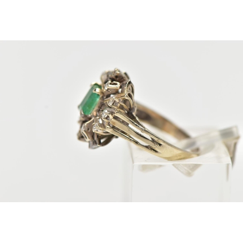 41 - A 1970s EMERALD AND DIAMOND CLUSTER RING, of geometric design, set with a principal rectangular cut ... 