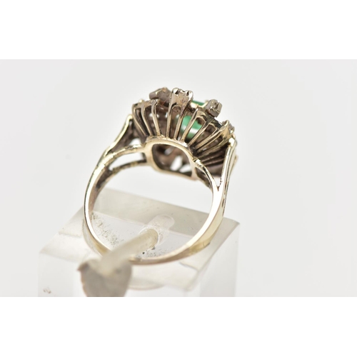 41 - A 1970s EMERALD AND DIAMOND CLUSTER RING, of geometric design, set with a principal rectangular cut ... 