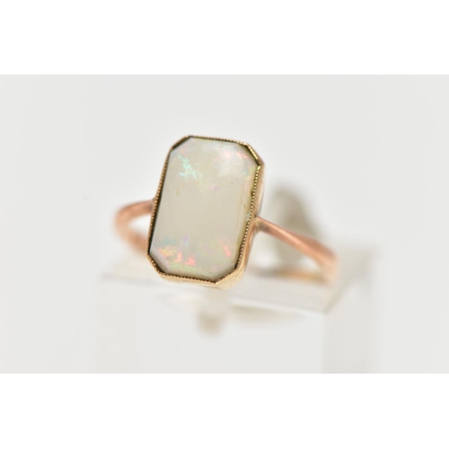 46 - A YELLOW METAL OPAL RING, rectangular cut opal cabochon with cut off corners, milgrain collet mount,... 