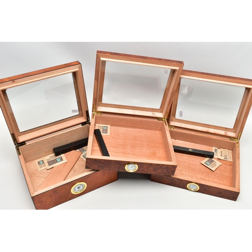 68 - THREE 'GERMANUS' AMBOYNA CIGAR HUMIDOR BOXES, two shallow wooden boxes with an open top glass panel,... 