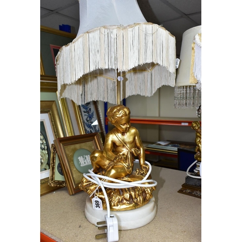 369 - A GROUP OF LAMPS AND GILT FRAMED PRINTS, comprising a small figural standard lamp with cherubs aroun... 