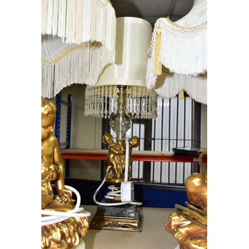 369 - A GROUP OF LAMPS AND GILT FRAMED PRINTS, comprising a small figural standard lamp with cherubs aroun... 