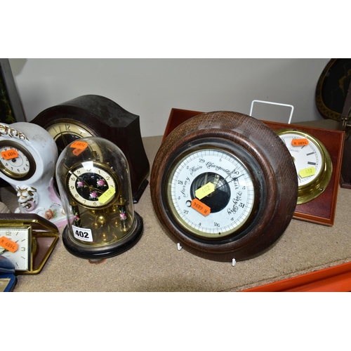 402 - A QUANTITY OF CLOCKS, comprising a Ron Coles native Australian Red Burl wood mantel clock, a wooden ... 