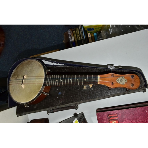 421 - A BARNETT SAMUEL DULCETTA UKULELE BANJO IN DISTRESSED CASE, the banjo has four tuning keys, total ap... 