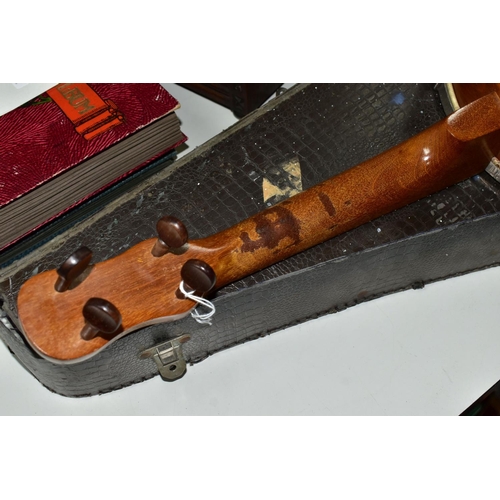 421 - A BARNETT SAMUEL DULCETTA UKULELE BANJO IN DISTRESSED CASE, the banjo has four tuning keys, total ap... 