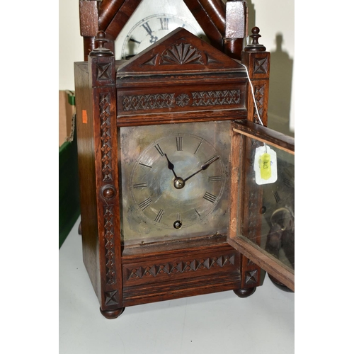 423 - A WINTERHALDER AND HOFMEIER OAK CARVED OAK MANTLE CLOCK, the silvered dial having roman numeral hour... 