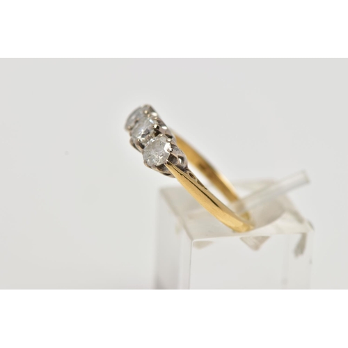 14 - AN 18CT GOLD THREE STONE DIAMOND RING, set with three round brilliant cut diamonds, each in a six cl... 