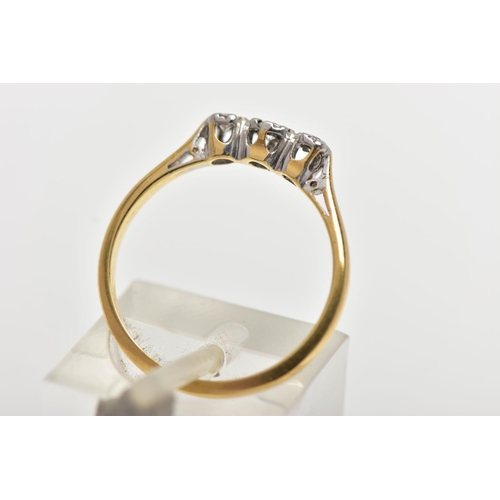 18 - A YELLOW AND WHITE METAL THREE STONE DIAMOND RING, three illusion set round brilliant cut diamonds, ... 