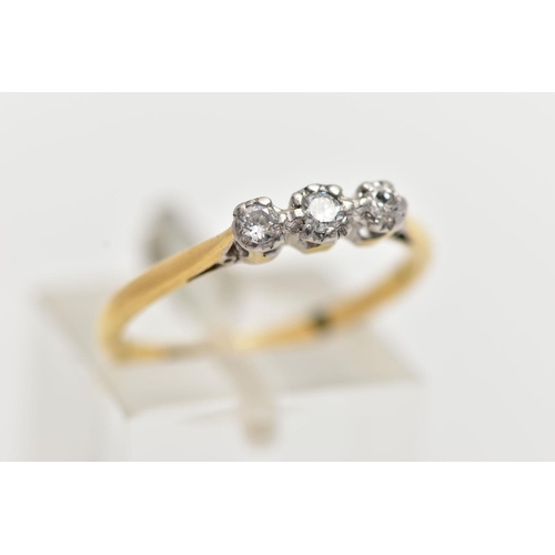 18 - A YELLOW AND WHITE METAL THREE STONE DIAMOND RING, three illusion set round brilliant cut diamonds, ... 